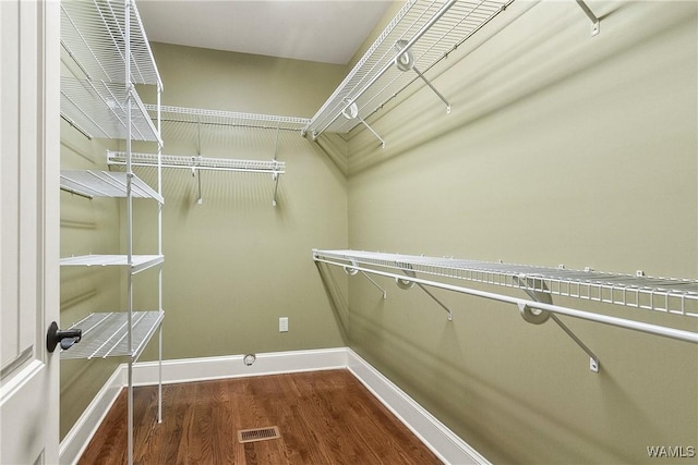 spacious closet featuring hardwood / wood-style flooring