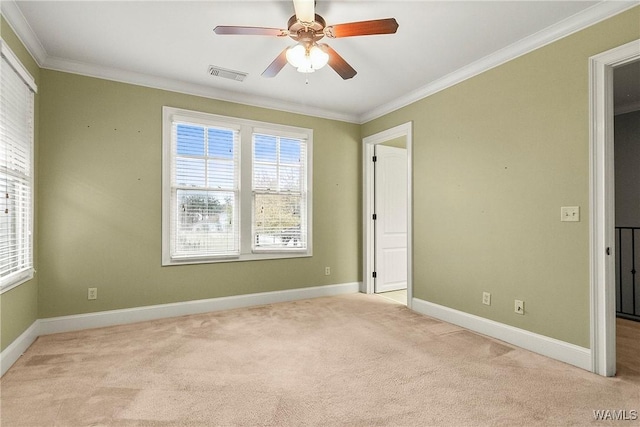 interior space featuring light colored carpet, ceiling fan, and ornamental molding