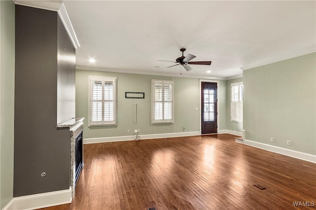 unfurnished living room featuring ceiling fan, crown molding, and a healthy amount of sunlight