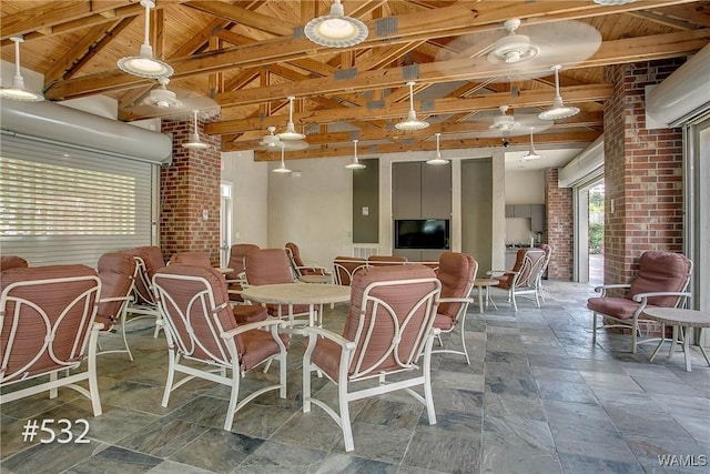 600 13th St E Unit 532, Tuscaloosa, AL 35401 - dining space featuring wooden ceiling, stone tile flooring, and brick wall