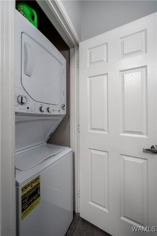 600 13th St E Unit 532, Tuscaloosa, AL 35401 - clothes washing area featuring stacked washer / dryer and dark tile patterned flooring