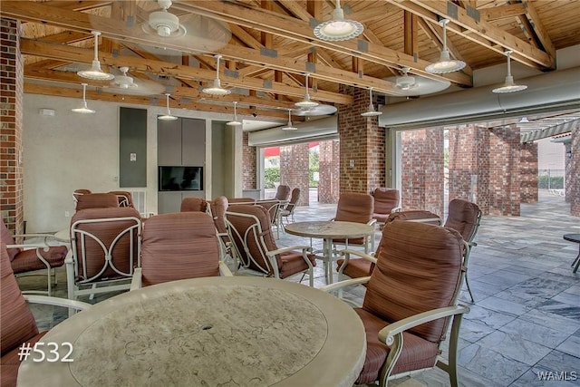 600 13th St E Unit 532, Tuscaloosa, AL 35401 - dining room with plenty of natural light, stone tile floors, brick wall, and wooden ceiling