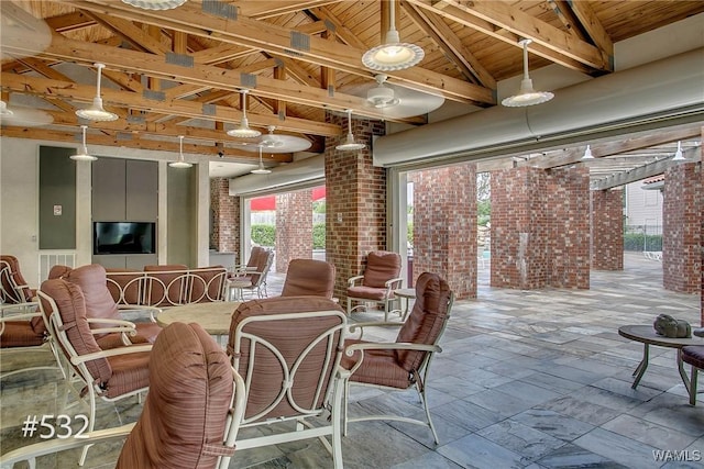 600 13th St E Unit 532, Tuscaloosa, AL 35401 - dining space featuring brick wall, plenty of natural light, and wooden ceiling