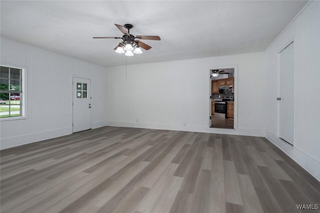 4205 Cloverdale Est, Northport, AL 35473 - unfurnished living room with ceiling fan, wood finished floors, and baseboards