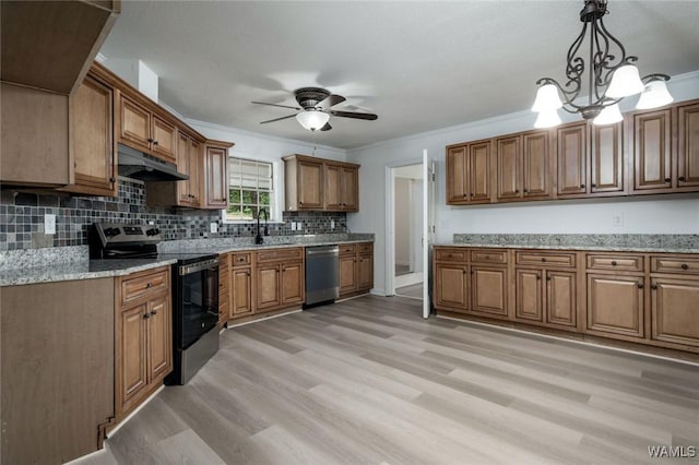 4205 Cloverdale Est, Northport, AL 35473 - kitchen with stainless steel appliances, under cabinet range hood, brown cabinets, light wood-style flooring, and crown molding