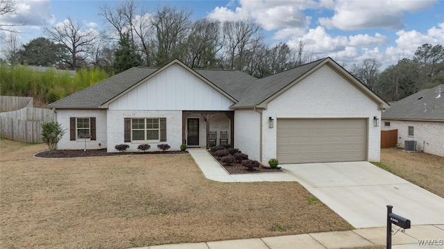 view of front of home with brick siding, a garage, concrete driveway, a front lawn, and board and batten siding