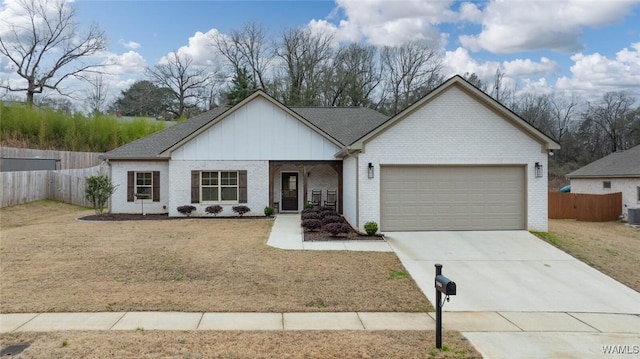 view of front of house featuring fence, brick siding, driveway, a garage, and board and batten siding