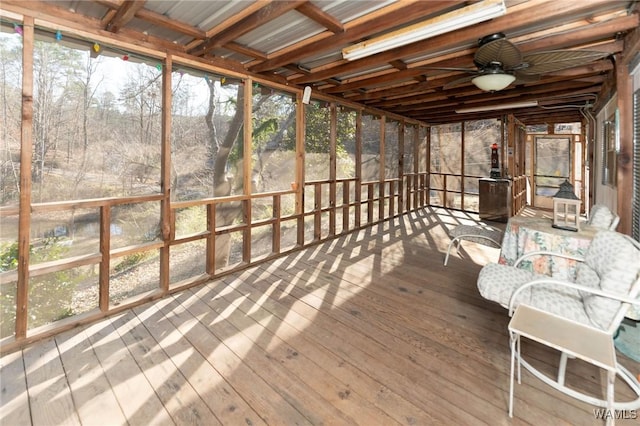 unfurnished sunroom featuring ceiling fan