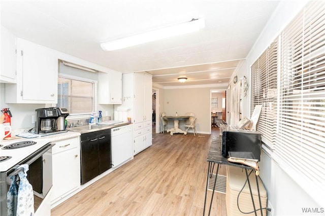 kitchen featuring white cabinets, light hardwood / wood-style floors, and white appliances