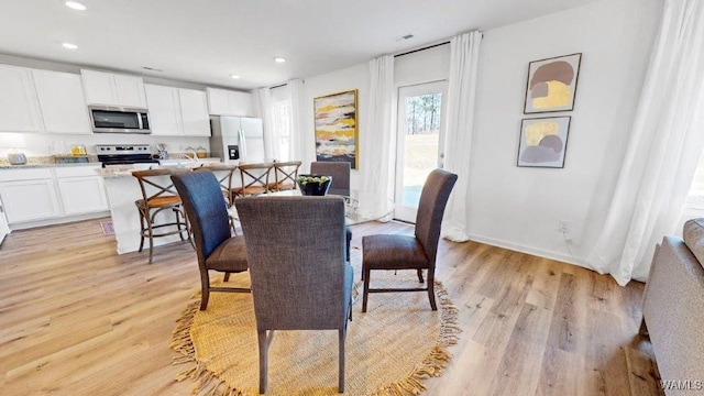 dining space with light wood-type flooring