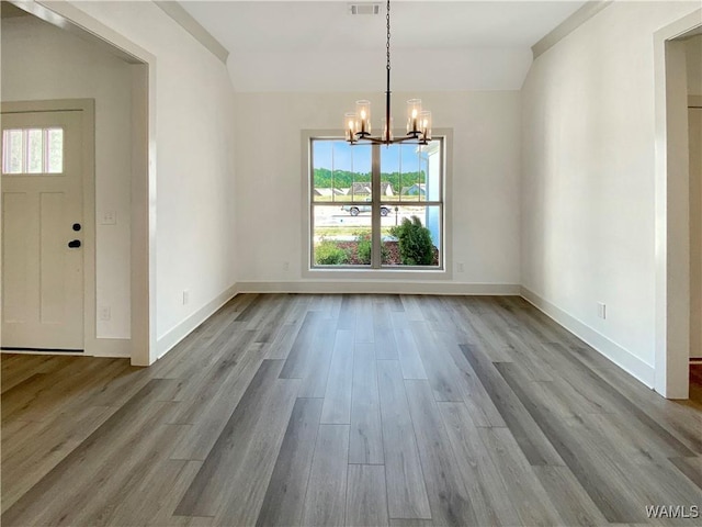 unfurnished dining area with light wood-type flooring and a chandelier