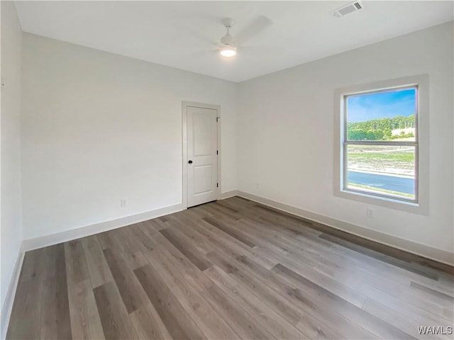 spare room featuring ceiling fan and hardwood / wood-style floors