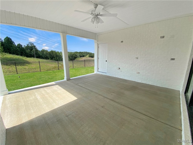 unfurnished sunroom featuring ceiling fan