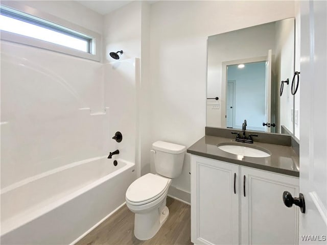 full bathroom featuring vanity, hardwood / wood-style floors,  shower combination, and toilet