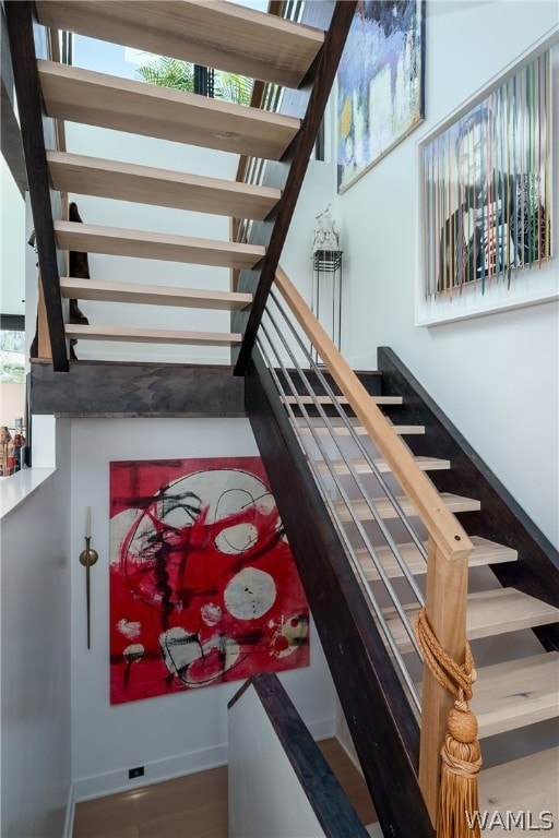 stairs featuring hardwood / wood-style flooring