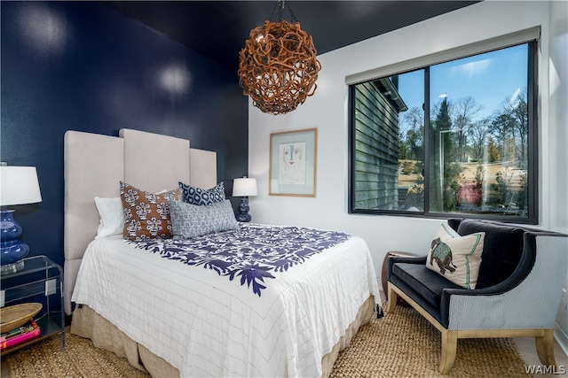 bedroom featuring an inviting chandelier