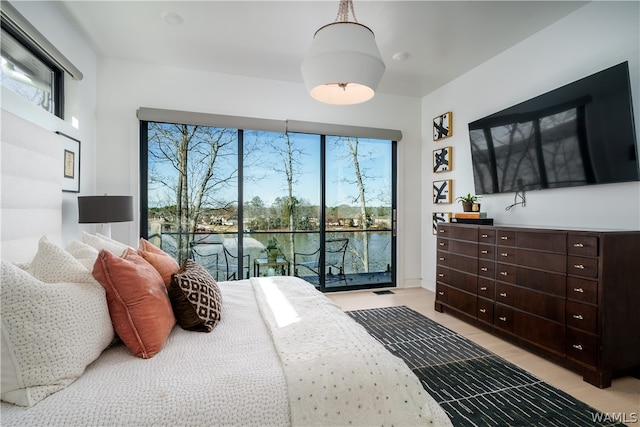 bedroom featuring access to exterior and light tile patterned floors