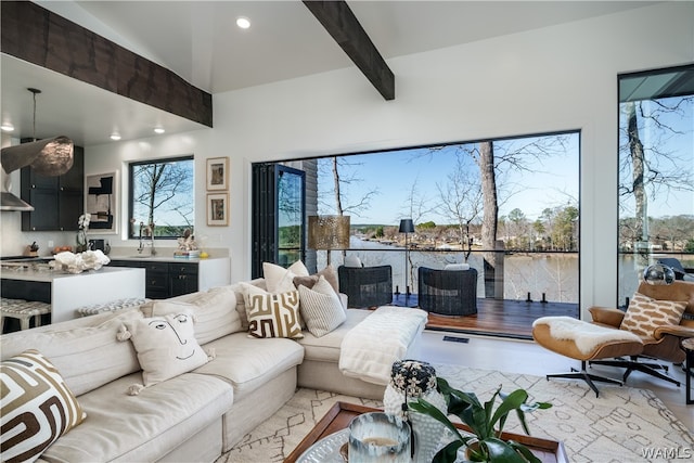 living room featuring lofted ceiling with beams and sink