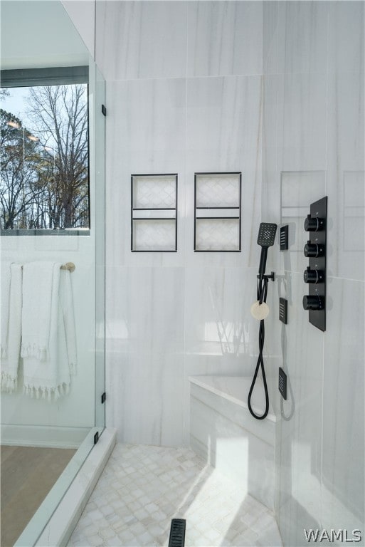 bathroom with tiled shower