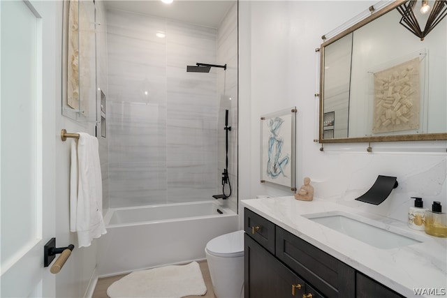 full bathroom with vanity, toilet, tiled shower / bath, and backsplash