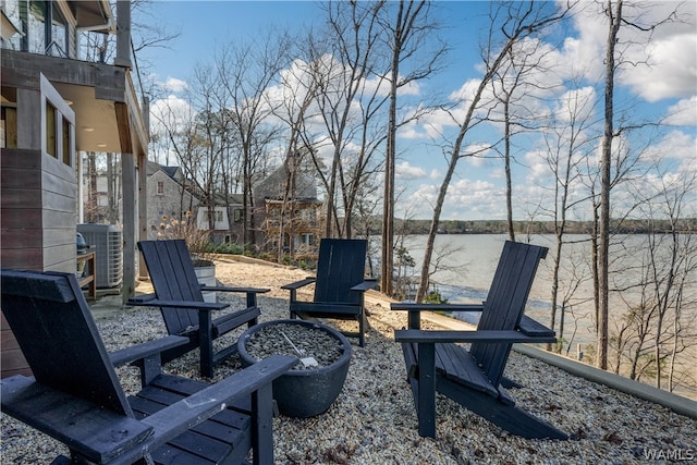 view of patio with central air condition unit and a water view