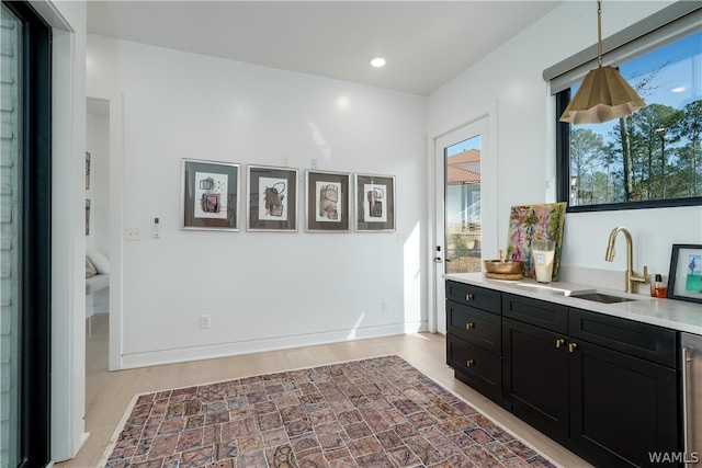 interior space with light hardwood / wood-style floors and sink