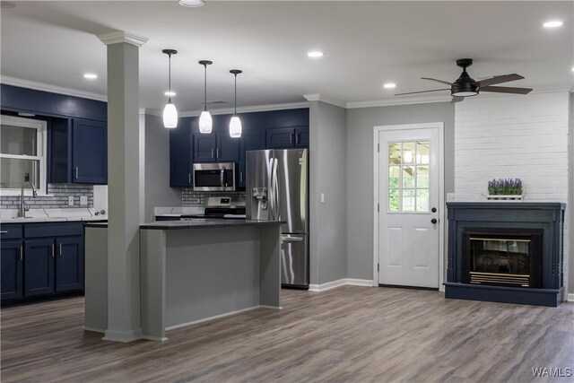 kitchen featuring decorative backsplash, blue cabinetry, ceiling fan, and stainless steel appliances