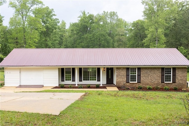 ranch-style home featuring covered porch, brick siding, metal roof, and a front yard