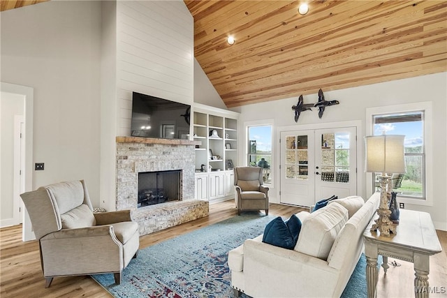 17505 Mormon Rd, Northport, AL 35475 - living room featuring wood finished floors, wooden ceiling, a fireplace with raised hearth, high vaulted ceiling, and french doors