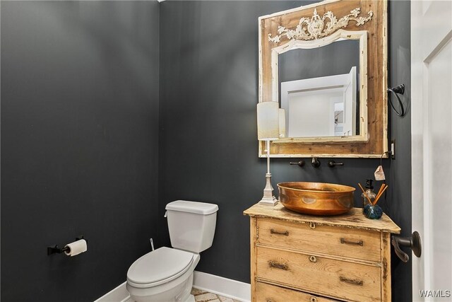 17505 Mormon Rd, Northport, AL 35475 - half bath featuring toilet, baseboards, and vanity