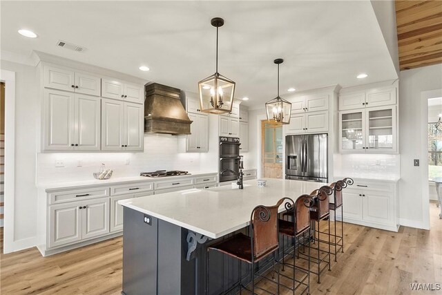 17505 Mormon Rd, Northport, AL 35475 - kitchen featuring custom range hood, a sink, decorative backsplash, light countertops, and white cabinets