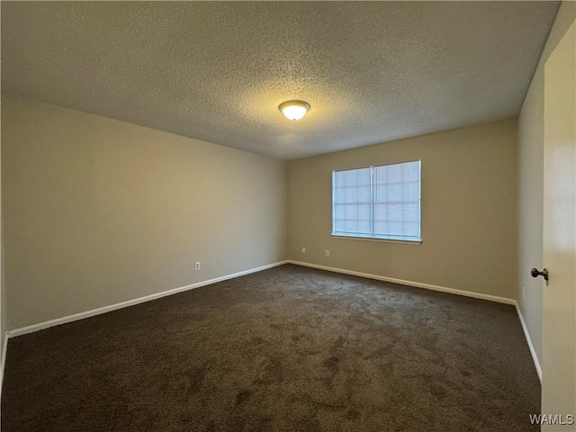 carpeted empty room with a textured ceiling