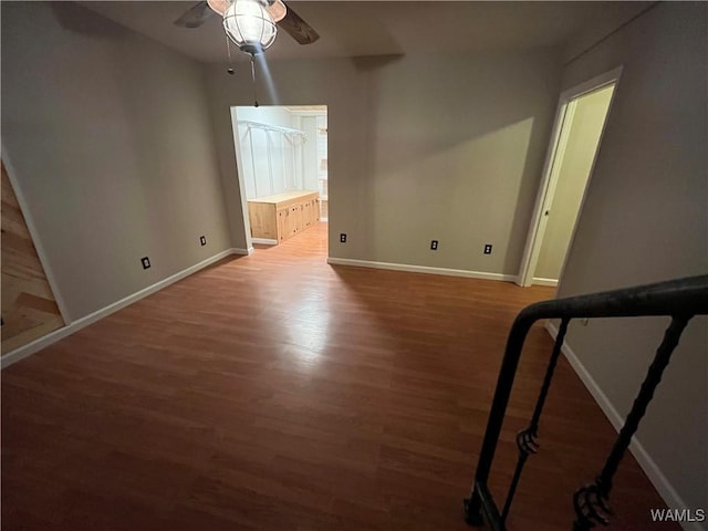 interior space with ceiling fan, baseboards, and wood finished floors