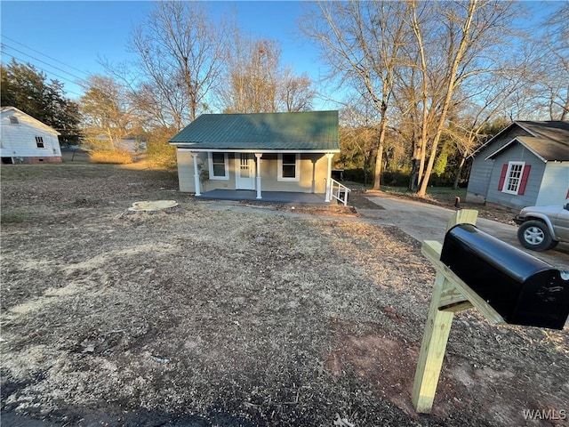 view of front of home with metal roof and a porch