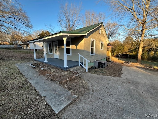 view of front of house with a porch and central AC