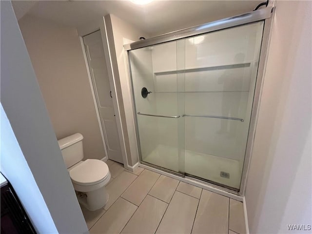 full bathroom with a shower stall and toilet