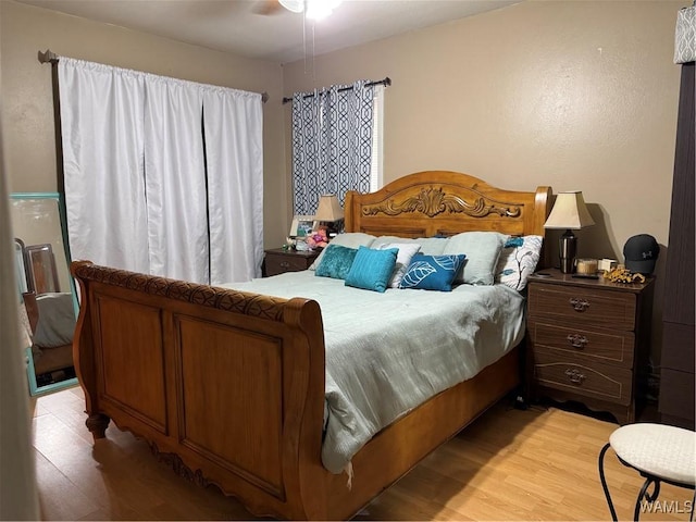 bedroom with ceiling fan and light wood-type flooring