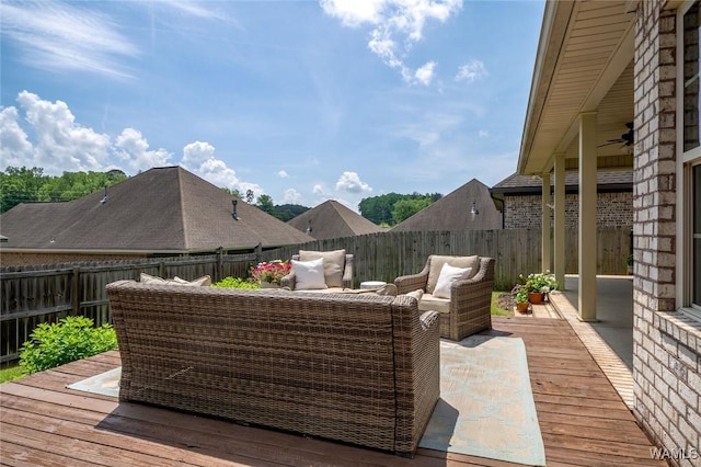 deck with a fenced backyard and an outdoor living space
