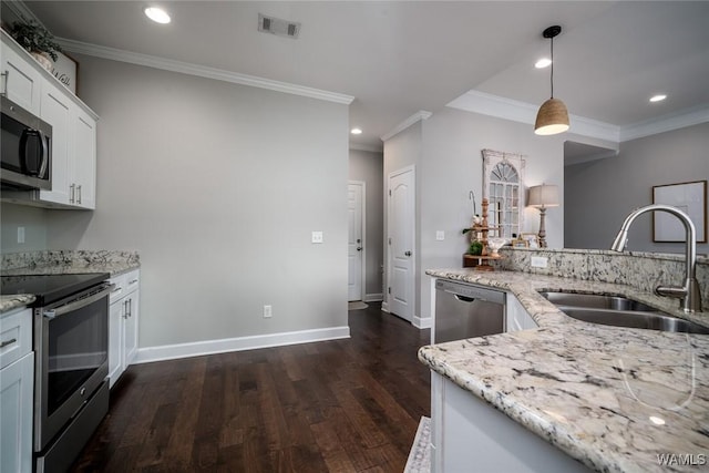 kitchen with ornamental molding, light stone countertops, a sink, dark wood finished floors, and appliances with stainless steel finishes