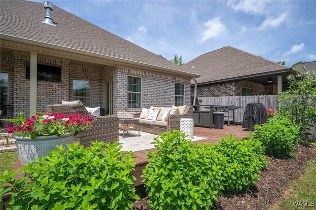view of patio with an outdoor living space, a wooden deck, grilling area, and fence