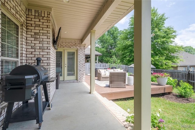 view of patio / terrace with a fenced backyard, an outdoor living space, a grill, and a deck