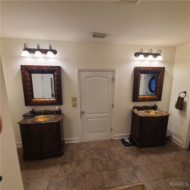 13712 Tab Dr, Northport, AL 35475 - full bath with baseboards, two vanities, and stone finish flooring