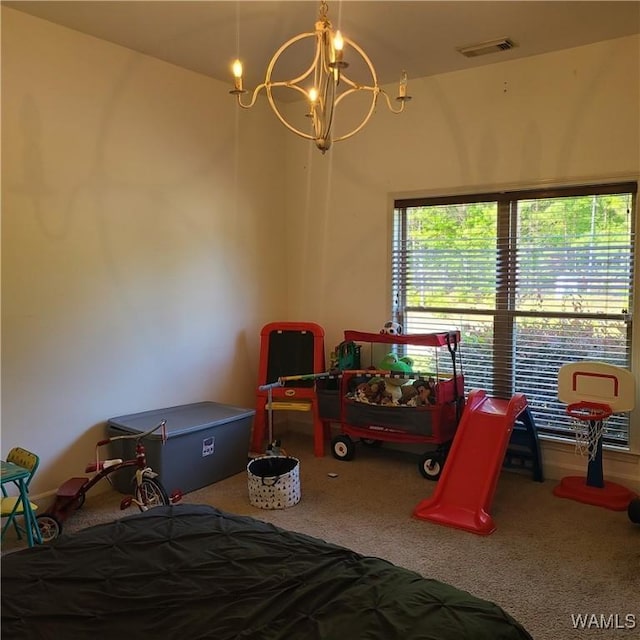 13712 Tab Dr, Northport, AL 35475 - bedroom with carpet and a chandelier