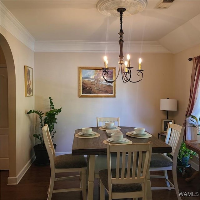 13712 Tab Dr, Northport, AL 35475 - dining area with arched walkways, wood finished floors, baseboards, a chandelier, and crown molding