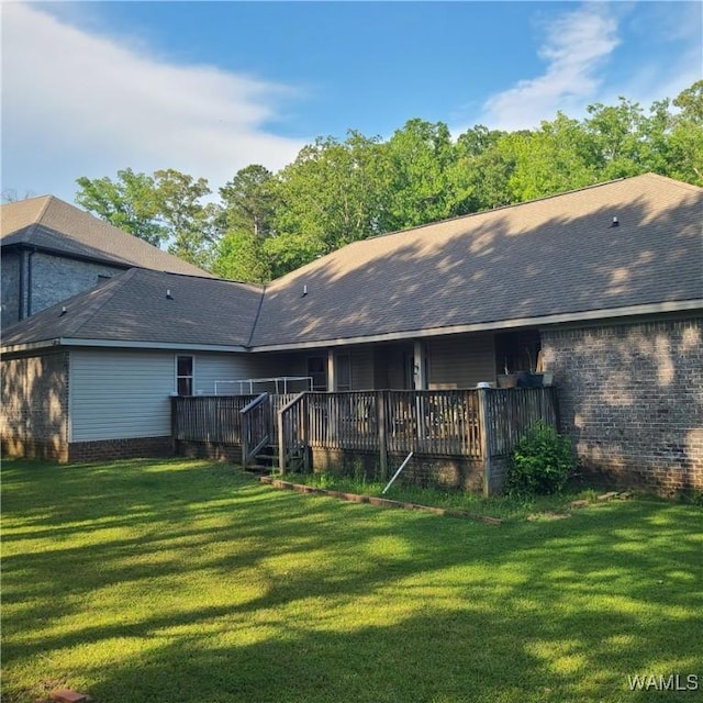 13712 Tab Dr, Northport, AL 35475 - back of house featuring a lawn, brick siding, and roof with shingles