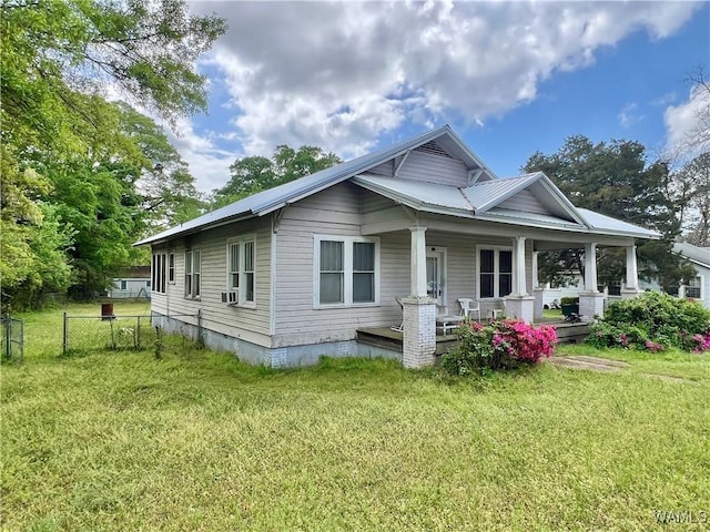 view of front of house with a front yard, a porch, and fence