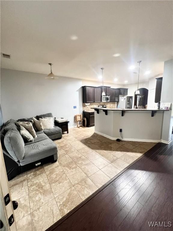 11627 Andrew Way, Tuscaloosa, AL 35405 - living room featuring baseboards, visible vents, and light wood-type flooring