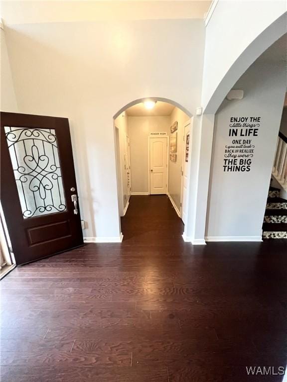 11627 Andrew Way, Tuscaloosa, AL 35405 - entrance foyer with stairway, wood finished floors, arched walkways, a towering ceiling, and baseboards