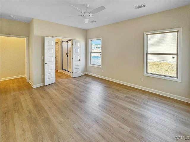 unfurnished bedroom with ceiling fan and light wood-type flooring