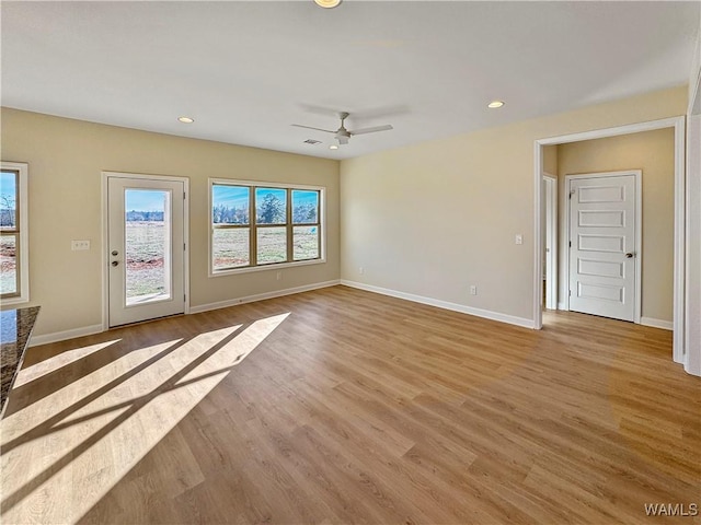 unfurnished living room featuring light hardwood / wood-style floors and ceiling fan